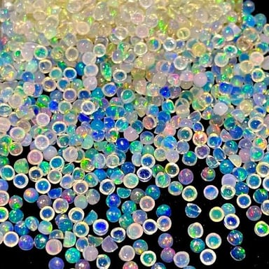 Opal gemstones displaying colorful iridescent flashes.