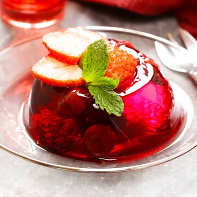 A dish of gelatin becoming firm in a refrigerator