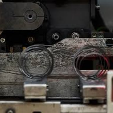 A close-up of a metal coil used inside an innerspring mattress.