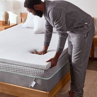 A padded mattress cover on a bed
