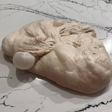 Bread dough expanding as fermentation creates gas bubbles.