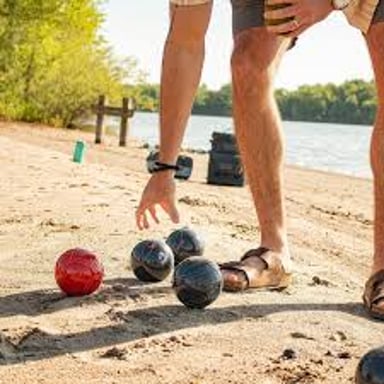 Players rolling bocce balls toward a small target ball