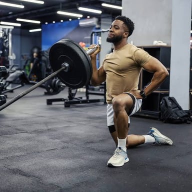 A muscular person lifting weights in a gym.