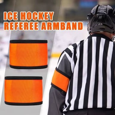A hockey referee in a black-and-white striped uniform with orange armbands stands on the ice.