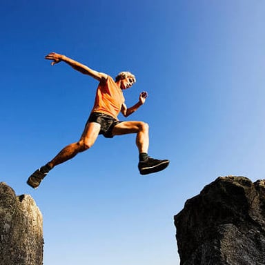 A person springing forward in a leap.