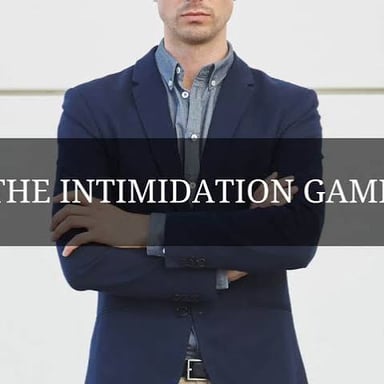 A person appears intimidated in a tense conversation, illustrating the meaning of cowed.