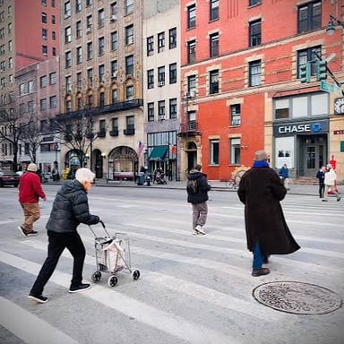 People walking along a city sidewalk.