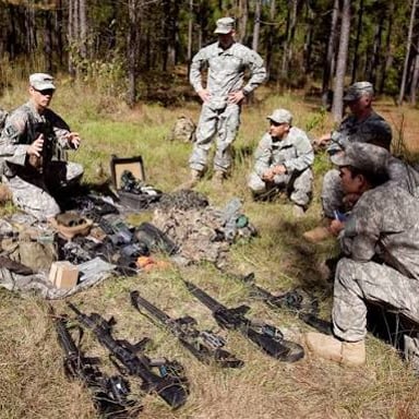 A scouting patrol surveying terrain to gather information.