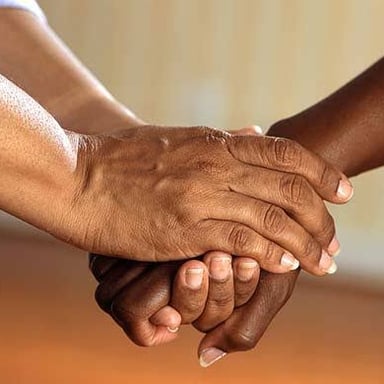 One person comforting another with a reassuring gesture