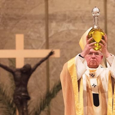 A ceremonial anointing with oil, a traditional way to bless or consecrate someone.