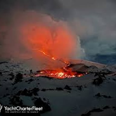 Mount Etna, an active volcano rising above the surrounding landscape in Sicily.