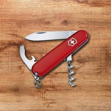 A Swiss Army knife with its folding can opener extended.