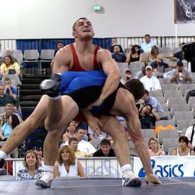 Wrestlers competing in Greco-Roman style, in which holds are restricted below the waist.