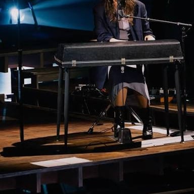 Singer-songwriter Sara Bareilles performing at a piano.