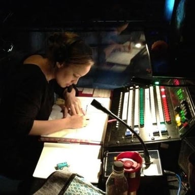 A stage manager signaling a performer to begin.