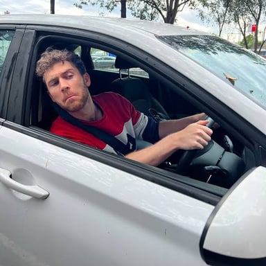 A driver glances toward activity beside the road, illustrating a rubbernecking onlooker.