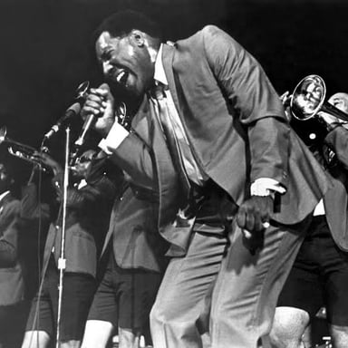 A portrait of soul singer Otis Redding performing.