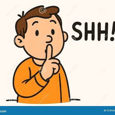 A person holding a finger to their lips to signal silence.