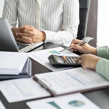 An auditor reviewing financial records and tax documents.