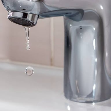 A drop of water falling from a faucet.