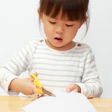 Scissors make a short cut through a piece of paper.