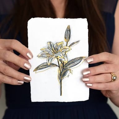 A lily decorated with gold-colored ornament, illustrating the idiom “gild the lily.”