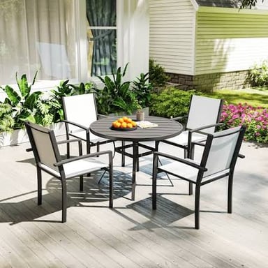 An outdoor patio furnished with a table and chairs.