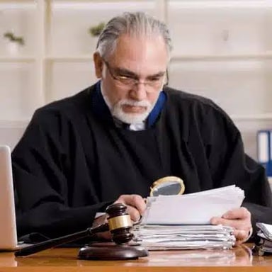 A judge reviews files related to legal cases.