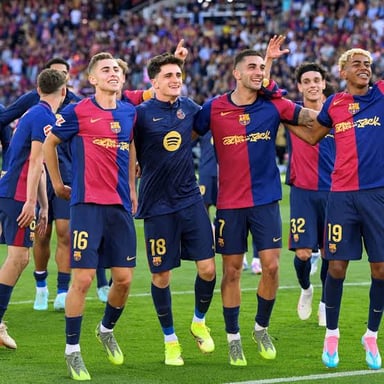 Players from FC Barcelona and Real Madrid competing in an El Clásico match.