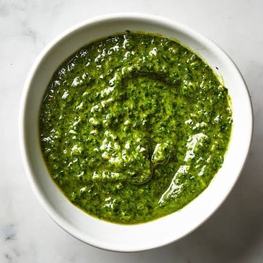A bowl of green basil pesto