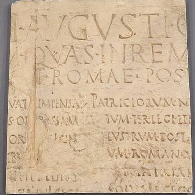 The Latin word est, meaning “is,” shown in a line of classical-style text.
