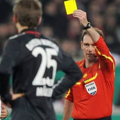 A referee signaling a decision during a sports match.