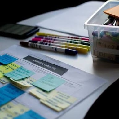 Planning documents and notes arranged on a desk.
