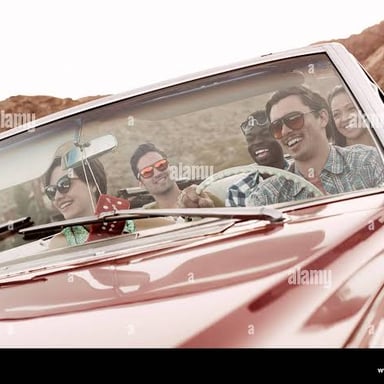 People casually driving around in a convertible car.