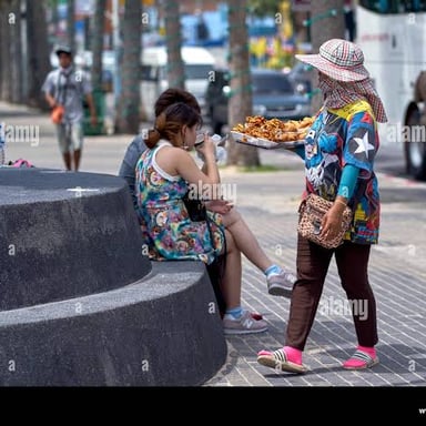 A street vendor actively offering merchandise to passersby.