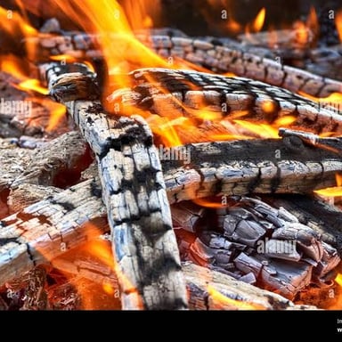 A piece of wood darkening as it burns.