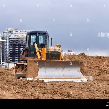 A bulldozer pushing debris while demolishing a structure