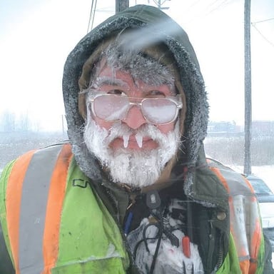A person working outdoors in cold, snowy weather.