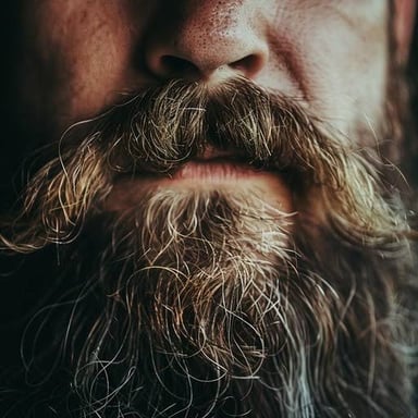 A close-up of a face with prominent unshaven whiskers.