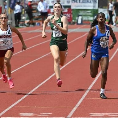 A sprinter running quickly on a track.