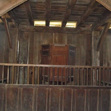 A stark, sparsely furnished interior associated with Puritan austerity.