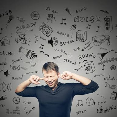A person reacting with irritation to a noisy distraction.