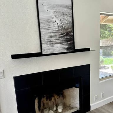 A shelf projecting above a fireplace.
