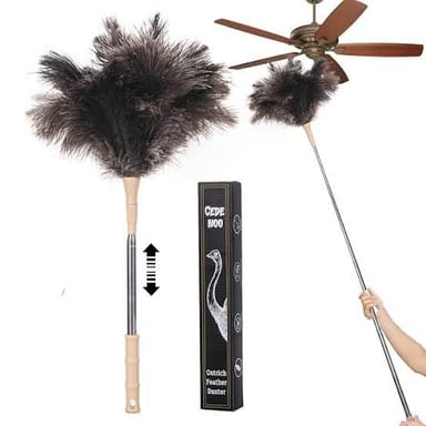 A feather duster being used to clean a piece of furniture.