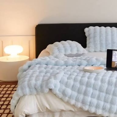 A soft, fluffy white pillow with a plush surface.