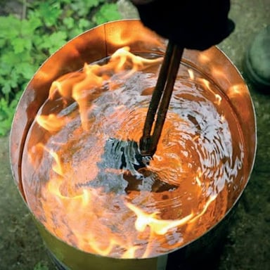 A piece of steel being heated and worked in a forge.
