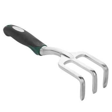 A wrench beside a garden rake.