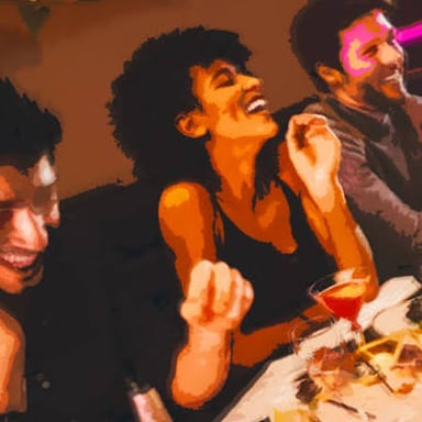 A person chatting animatedly with others at a social gathering.