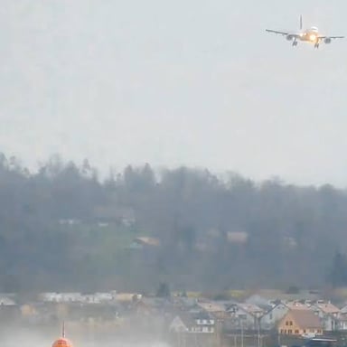 An airplane climbs away from a runway during a go-around.