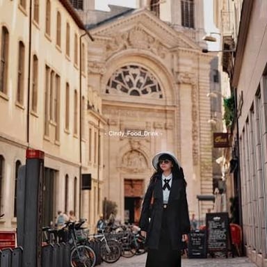A woman walking on a street in Lyon, France